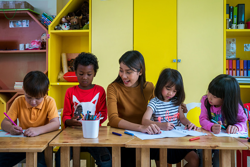 Teacher in her classroom with four students