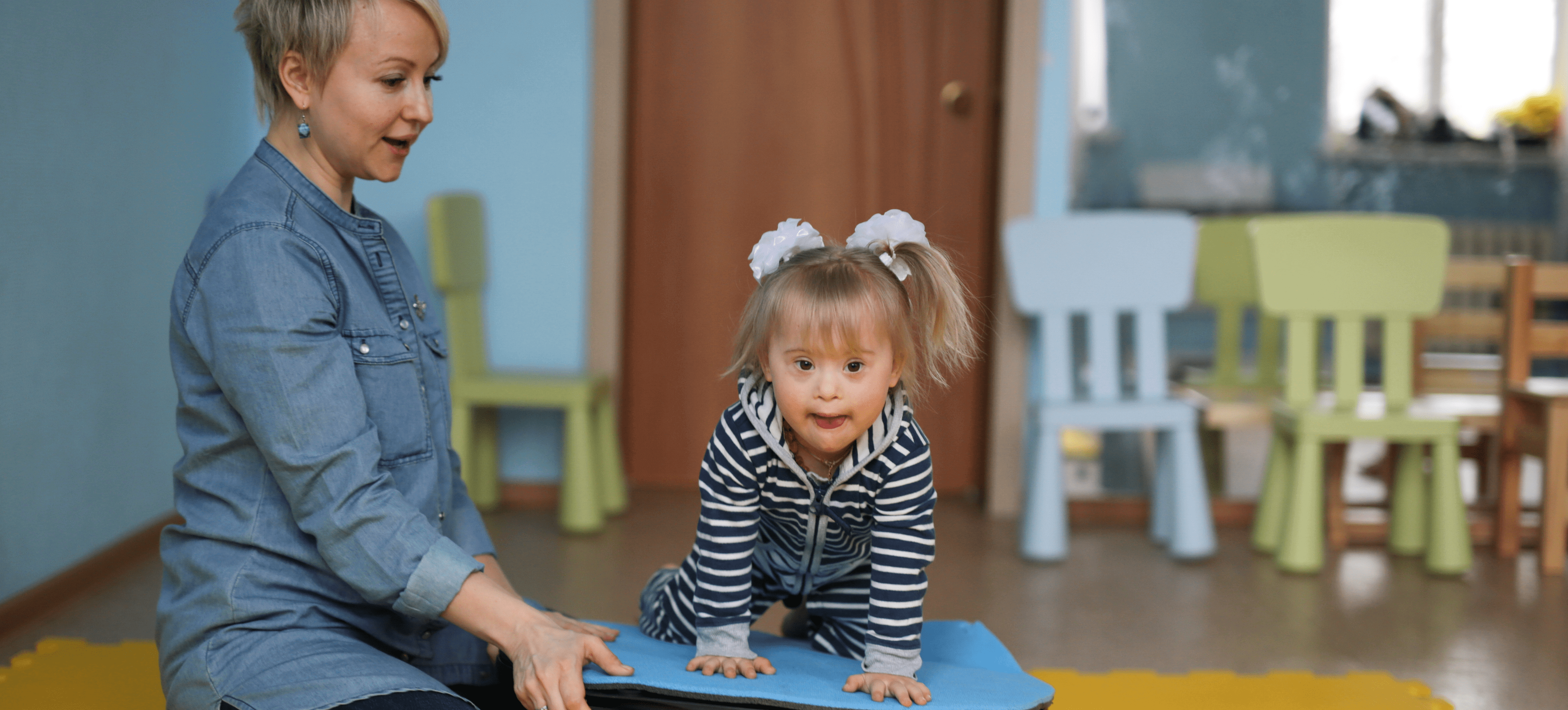 Child with her teacher in the classroom